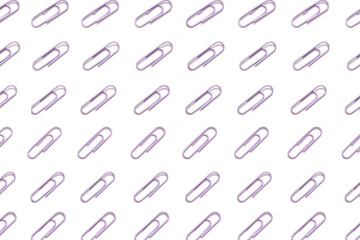 Decorative, pastel purple paper clips pattern on white background minimal creative concept.