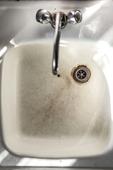 old rusty sink with drinking water