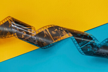 Old 35 mm Photographic film strip, negative on bright colorful background. Fashion Minimalism