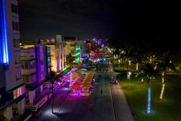 Ocean Drive Miami Beach night neon lights and tourists walking