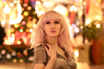 Obraz na płótnie Canvas blond woman close up portrait with Christmas illuminated decorations close up photo