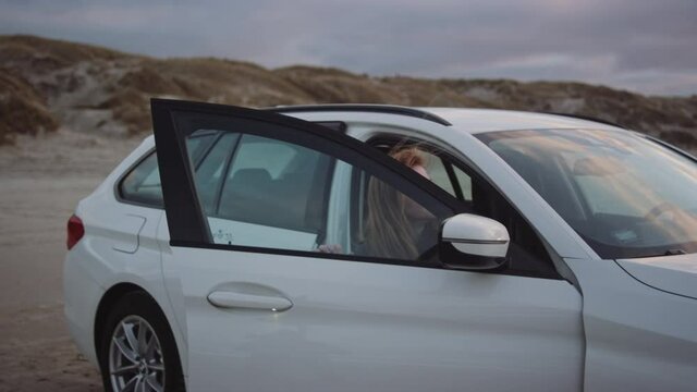 Teenager Getting Out Of Car To Walk On Beach