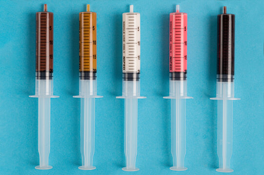 syringes stuffed with milk and white chocolate, caramel, strawberry and dark chocolate 
