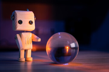A small wooden toy robot looks at a glass ball in the dark. wallpaper, blured background. low light