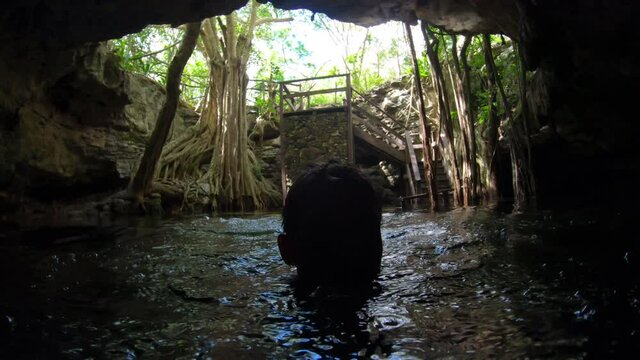 Man swimming in Dzonbacal cenote - Yucatan, Mexico 4K