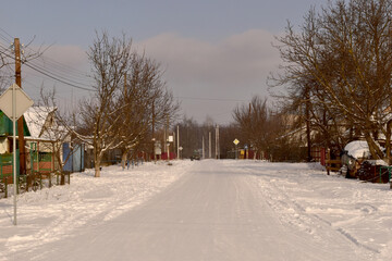 The road of a large village cleared of snow.
