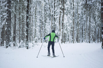 Fototapeta na wymiar Cross country ski. Skiing in winter on the track.