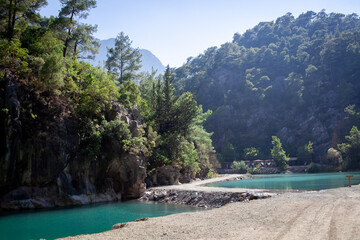 Fototapeta na wymiar Lake with blue and green water is surrounded by rocks in canyon Goynuk, Kemer district in Antalya Province, Turkey.