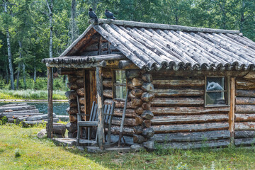 wooden cottage next to a river and a wooden walkway