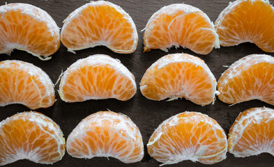 Close-up of some natural, fresh, healthy and tasty orange segments.