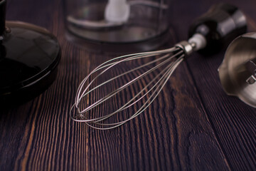 blender and whisk on a wooden table