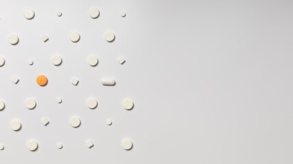 One colored pill on a background of white pills