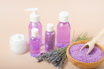 Fototapeta na wymiar cosmetics lavender, shampoo, oil, salt with lavender on a beige