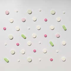 Multicolored pills on white background, pattern