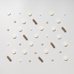 Multicolored pills on white background, pattern
