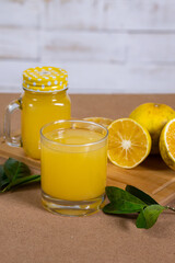 orange juice served in a glass cup made with natural oranges