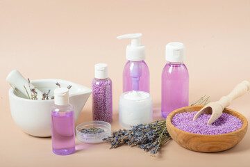 Obraz na płótnie Canvas set of cosmetics with lavender on a beige background
