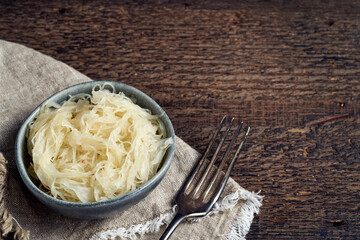 Fermented cabbage in a blue bowl with copy space