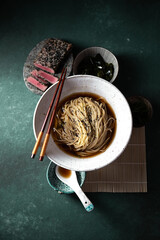 Japanese ramen. Asian soup with noodles ramen, miso, fried tuna steak and seaweed algae