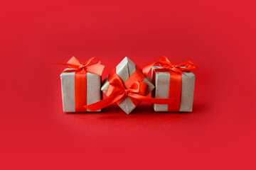 Close up composition with gifts on red background. Minimalist concept for Valentines day,  Mothers day, Women day or wedding. Greeting card with copyspace.