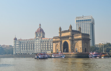 Naklejka premium Beautiful Gateway of India near Taj Palace hotel on the Mumbai harbour with many jetties on Arabian sea