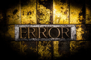 Error text formed with real authentic typeset letters on vintage textured silver grunge copper and gold background