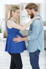 happy pregnant woman and her husband waiting for baby