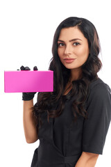 Attractive cosmetologist in uniform holding pink paper box
