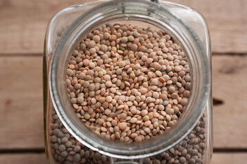 Lentils in glass jar on rustic table