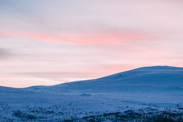 sunset in the mountains, after the dark period of no sun