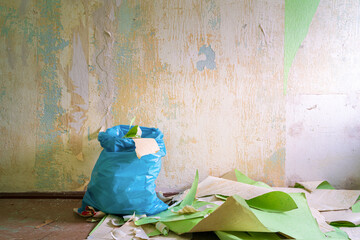 Peeling off wallpaper during interior home repair renovation and disposal of waste