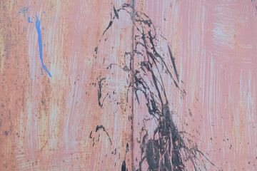 Scratched red-painted metal background. Abstract vintage texture.