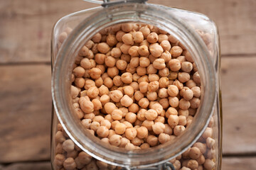 Chickpeas in glass jar on rustic table
