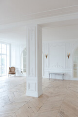 chic white huge spacious hall with a minimum of expensive antique furniture. Baroque interior...