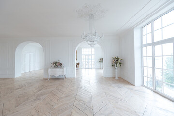 chic white huge spacious hall with a minimum of expensive antique furniture. Baroque interior...