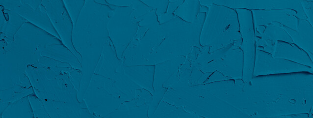 blue textured background of filler paste applied with putty knife in irregular dashes and strokes