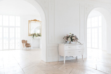 chic white huge spacious hall with a minimum of expensive antique furniture. Baroque interior...