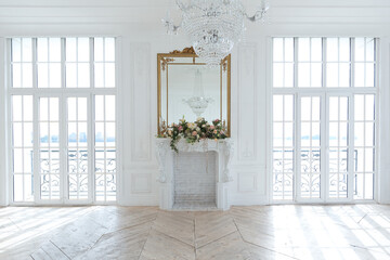 chic white huge spacious hall with a minimum of expensive antique furniture. Baroque interior...