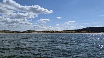 Beautiful clouds floating over a large body of water.