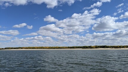 Beautiful clouds floating over a large body of water.