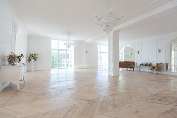 chic white huge spacious hall with a minimum of expensive antique furniture. Baroque interior...