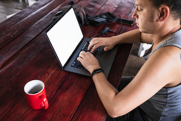 Digital nomad man working in a cabin in the jungle