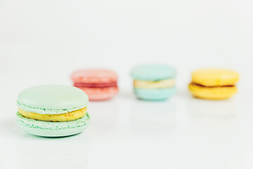 Sweet almond colorful pastel pink blue yellow green macaron or macaroon dessert cake isolated on white background. French sweet cookie. Minimal food bakery concept Copy space