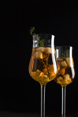 Pear drink in a glass goblet on a black background. Food styling. Menu design. Copy space