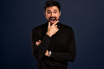 Waist-up portrait joyful enthusiastic young bearded man in trendy sweater, laughing and touching bristle as getting curious, stare entertained and amused,smiling broadly, stand Pacific Blue background