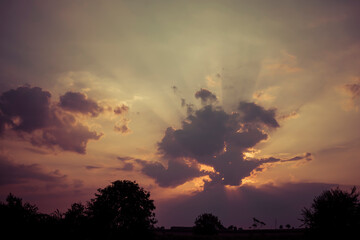 sun hiding behind cloud