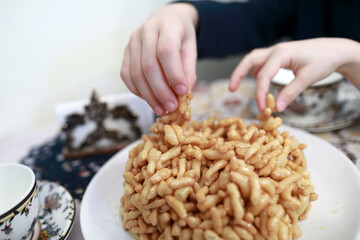 Children eating chak-chak dessert