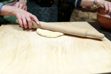Woman rolling dough for cooking chak-chak