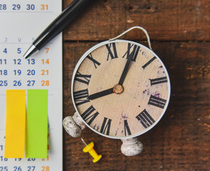 Close-Up Of Calendar With Alarm Clock 
