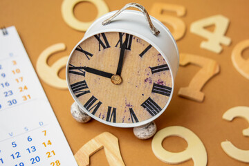 Close-Up Of Calendar With Alarm Clock 